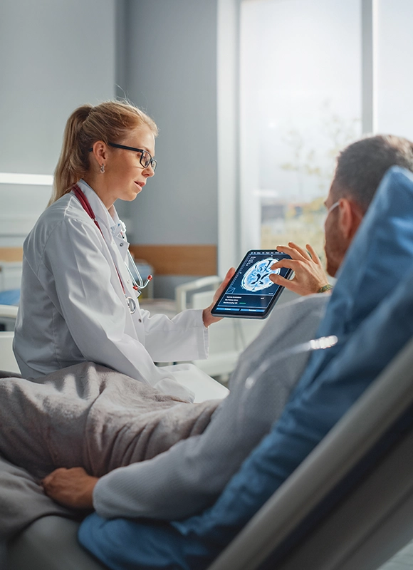 Physician reviewing EEG details on tablet with patient