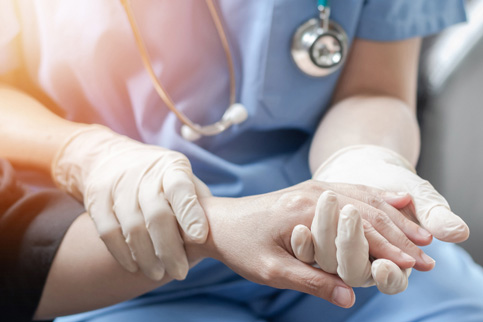 Medical Professional holding patient's hand
