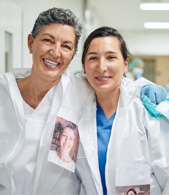 Two Vituity physicians wearing white lab coats smiling